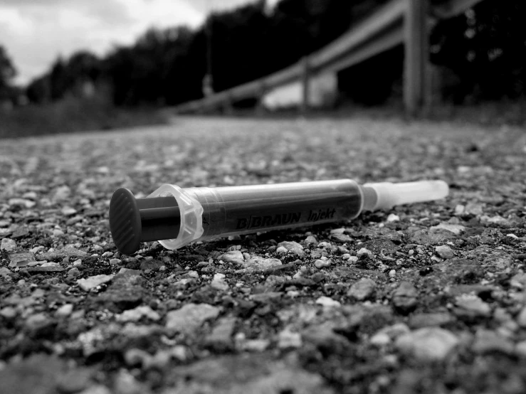 a bullet shaped object laying on some rocks