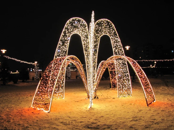 a long display with lit up arches of lights in the background