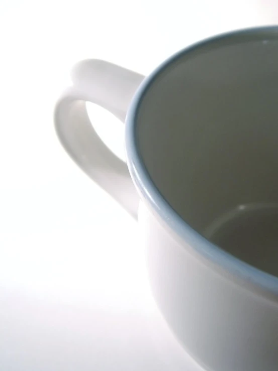 a close up of a cup on a white table