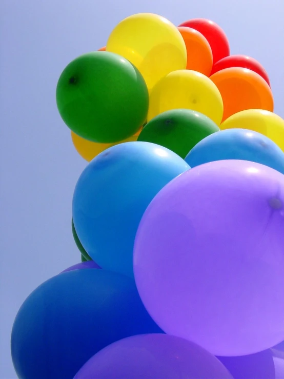 a number of balloons are floating in the air