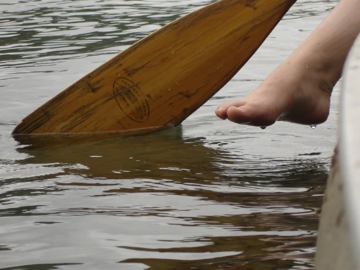 a person with their foot on a paddle boat