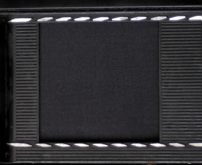 a picture frame with metal stripes and a black background