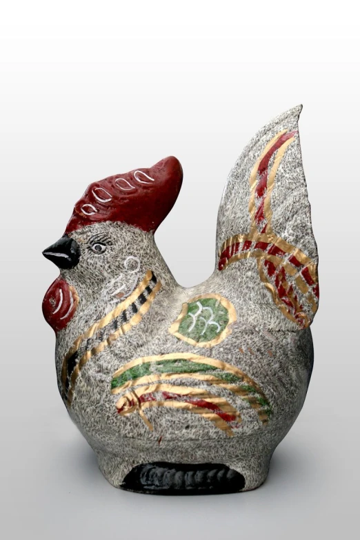 ceramic chicken sculpture sitting on a white surface