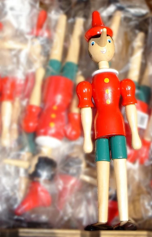 toy baseball player stands on a box of sticks