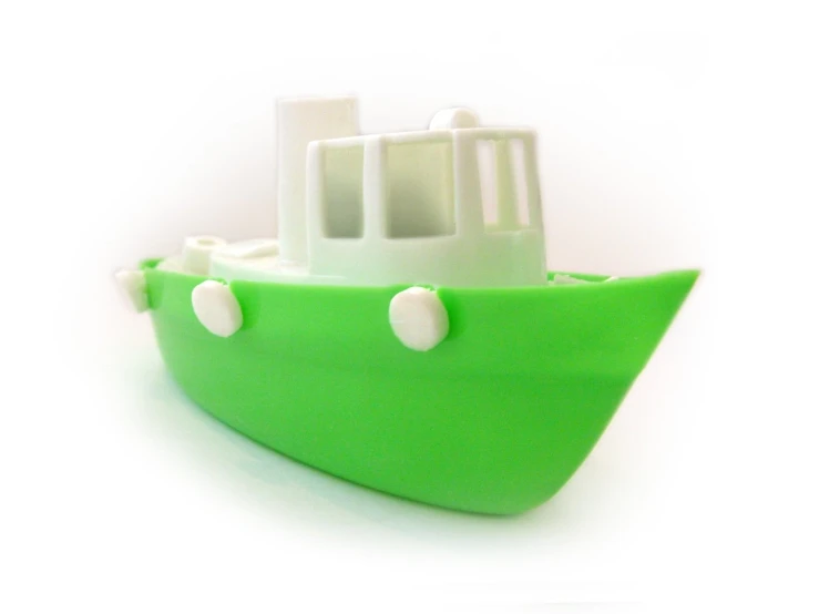 a green plastic boat with some white plastic parts on it