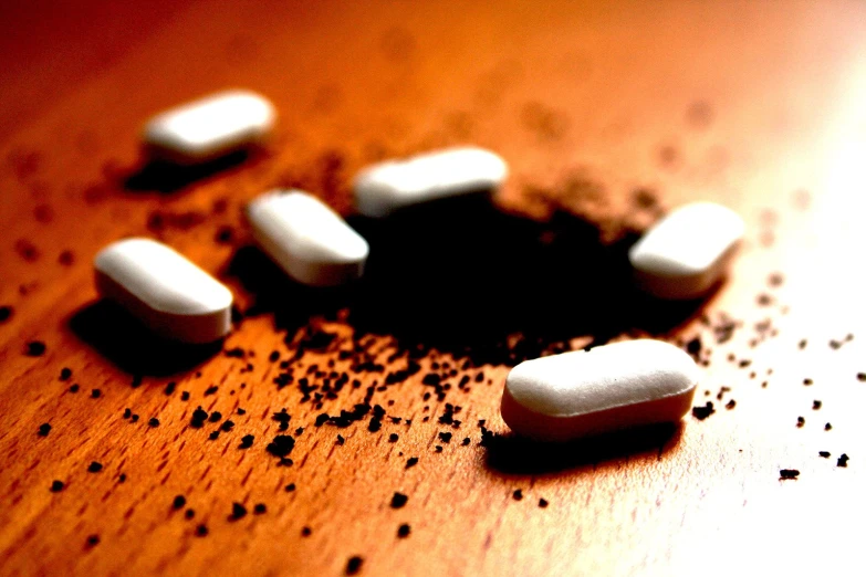 pills spilled on top of a wooden table