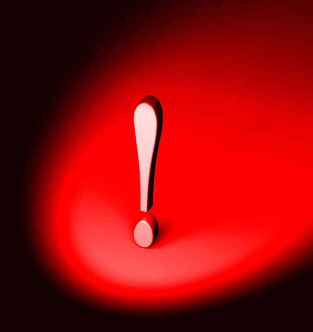 a single red object sits on a dark surface