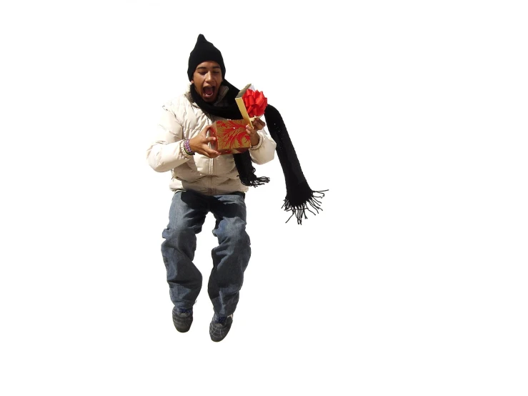 man jumping up into the air while wearing a hat and scarf