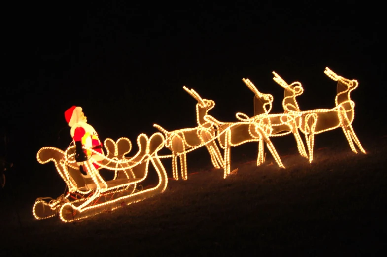 a man pulling a sleigh with santa claus on it in the dark