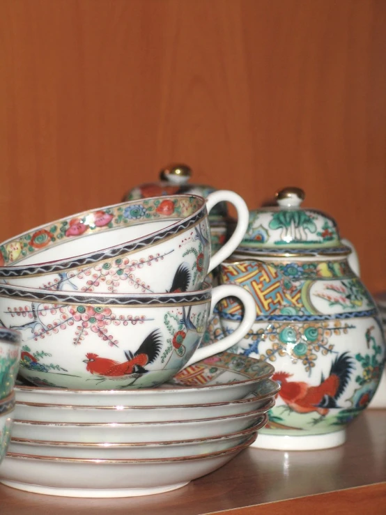 a set of three tea cups and a saucer and saucer