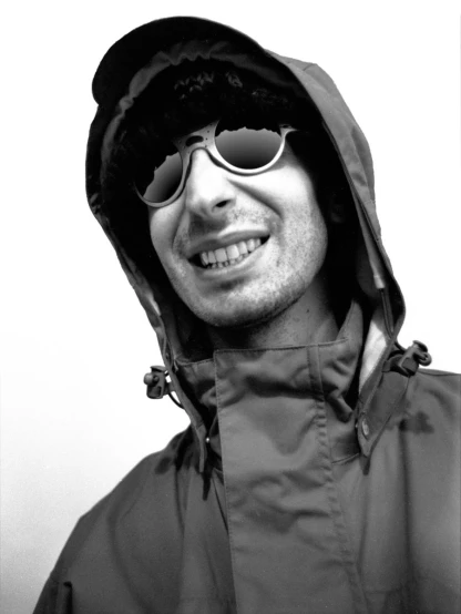 a man wearing sunglasses and a hooded jacket