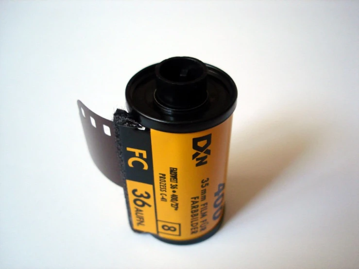 an empty film strip on top of a yellow and black camera