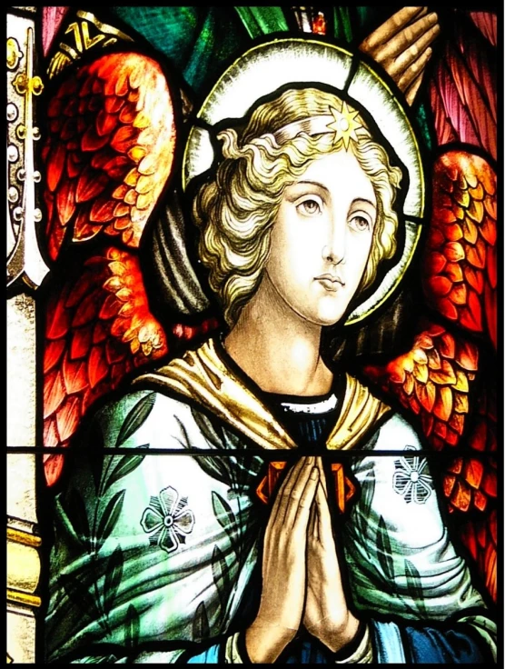 a close up of a stained glass with an angel