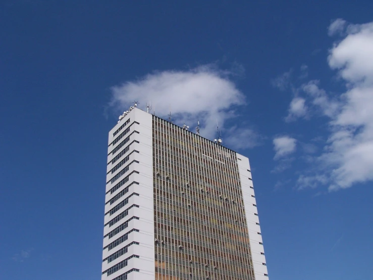 a very tall building towering over some buildings