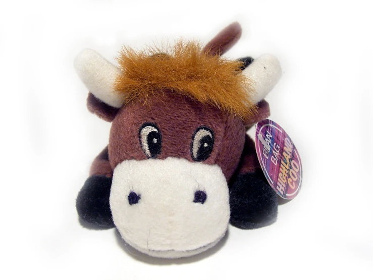 a stuffed animal cow with big eyes is shown