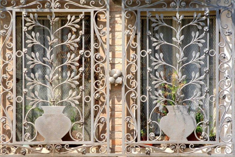 two vases with plants are on the window sill