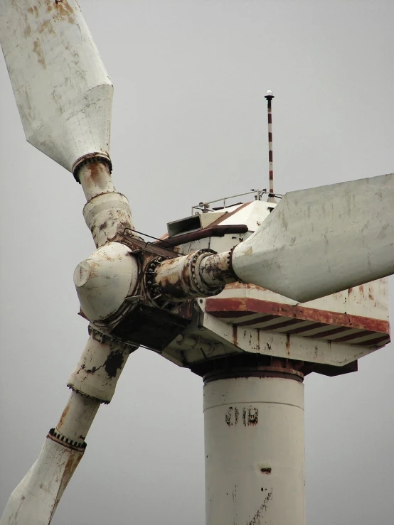 an old windmill is shown with rust and paint