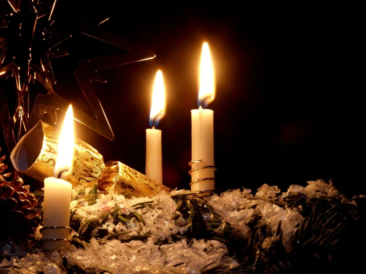 candles and pineconing are lit near the top of a table