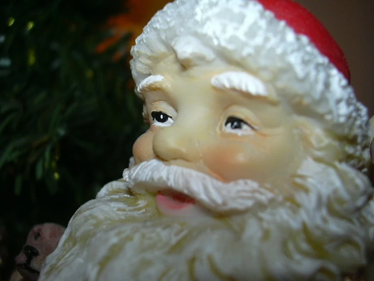 a santa figurine with a beard and hat on