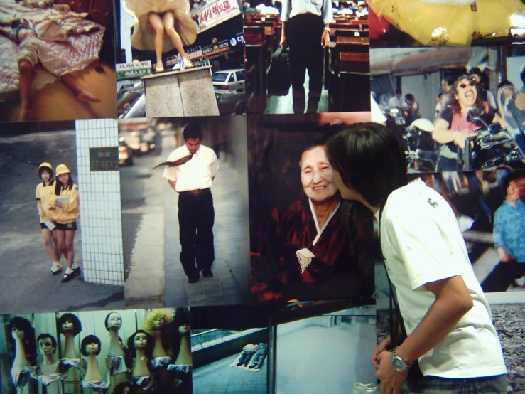 a man standing next to a woman in front of pos of people