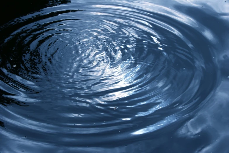 ripples in water surrounding a circular object that appears to be an object