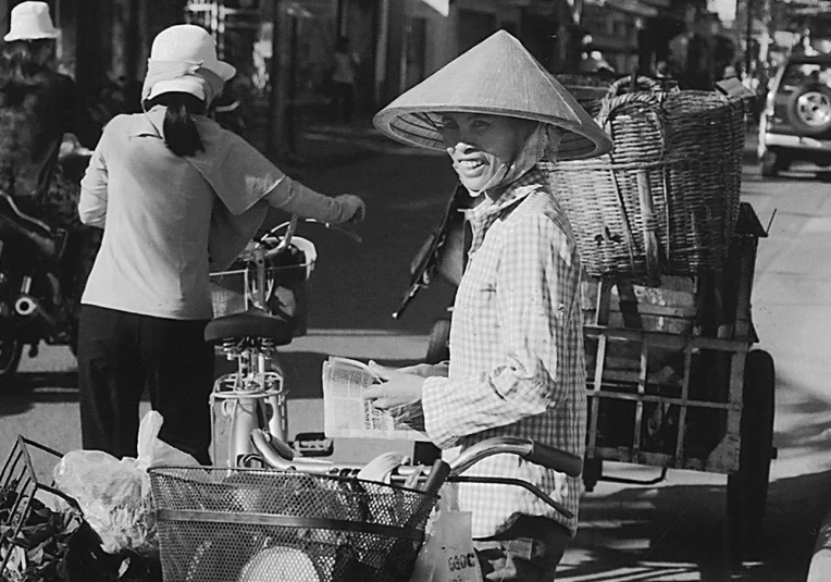 two women riding motorcycles on a city street