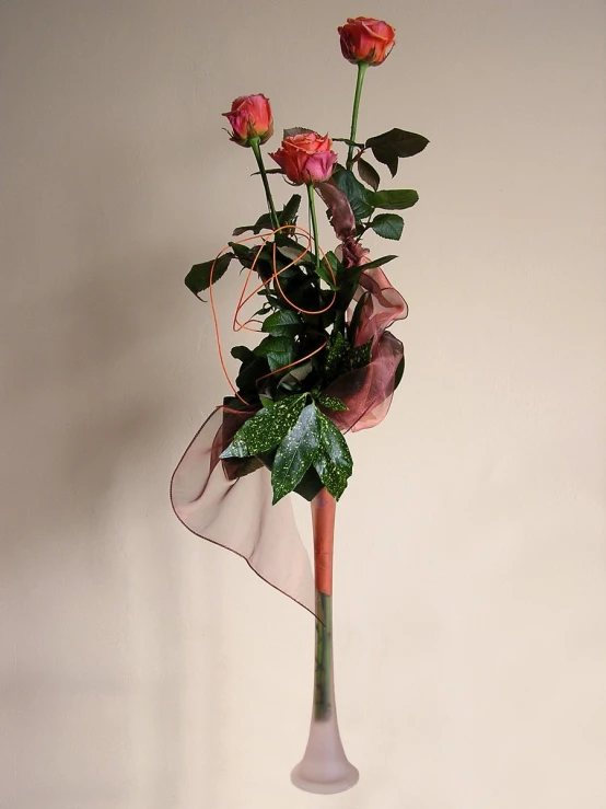 the vase is holding a large bundle of roses