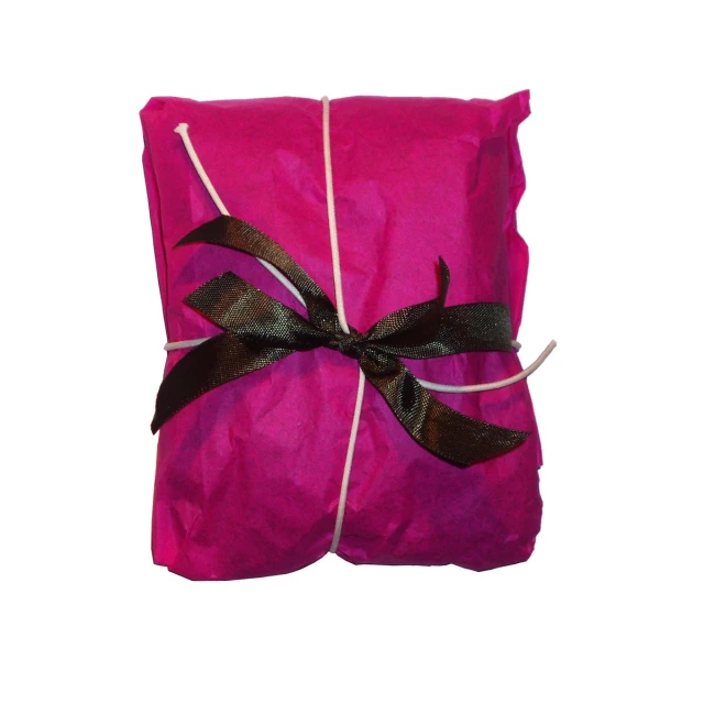 a pink blanket that is wrapped in ribbon and tied with black ribbon