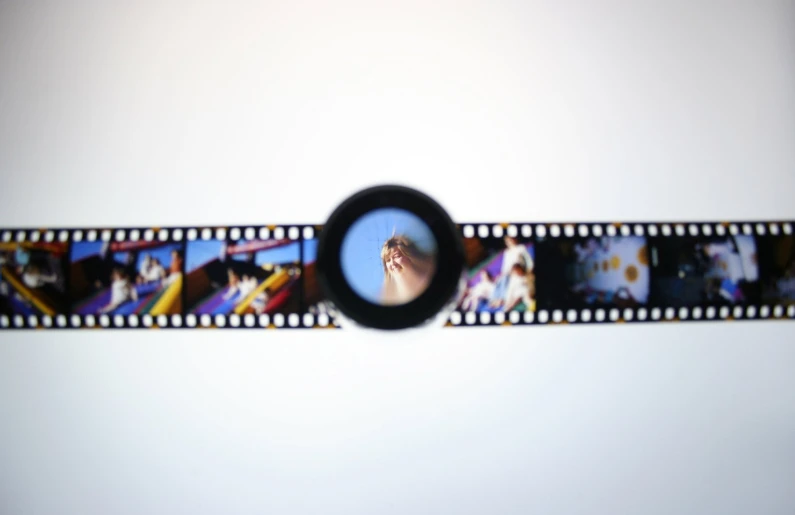 a film strip with film images and a small circle
