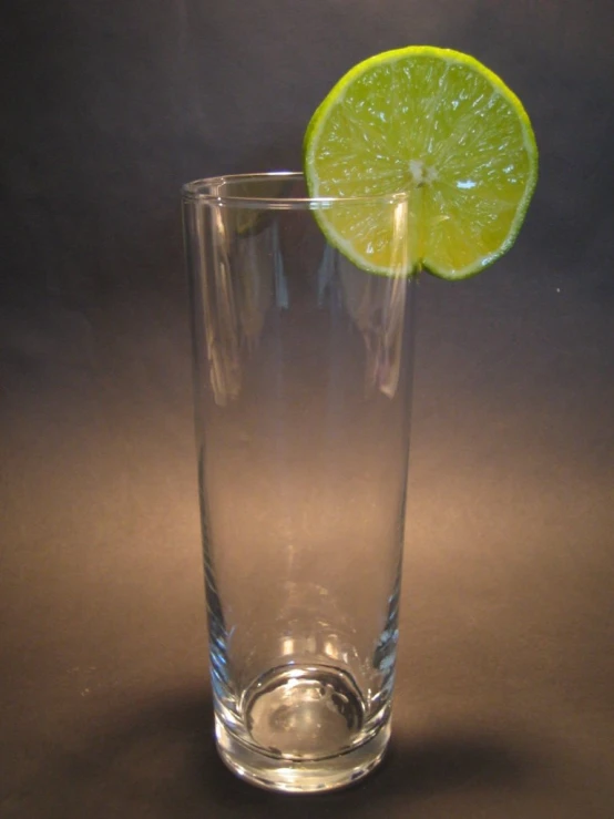 the top half of a lime in a glass