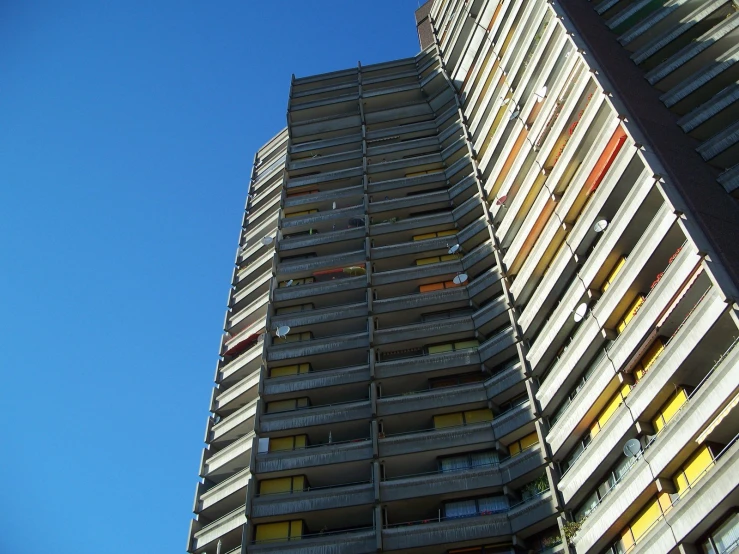 an apartment building stands in front of a blue sky