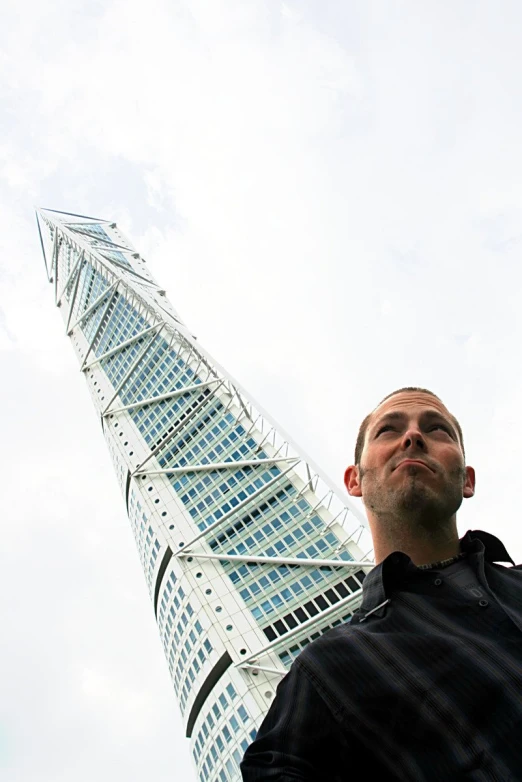 the man is looking up into the air near the building