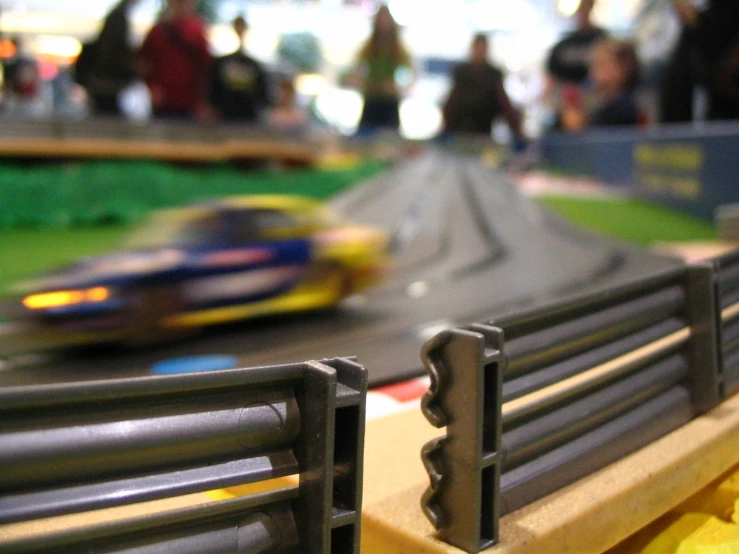 toy cars race through a track on top of plastic