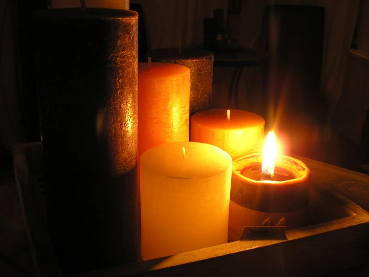 candles light up with a single lit candle