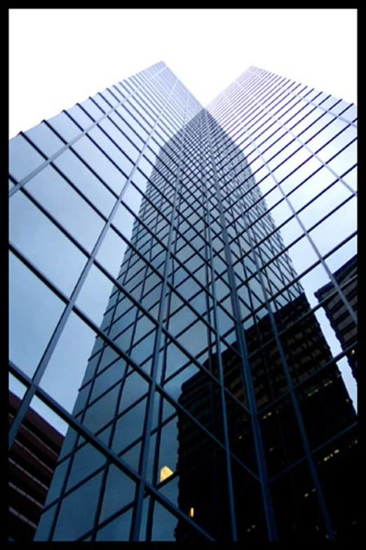 a very tall building with many windows next to it