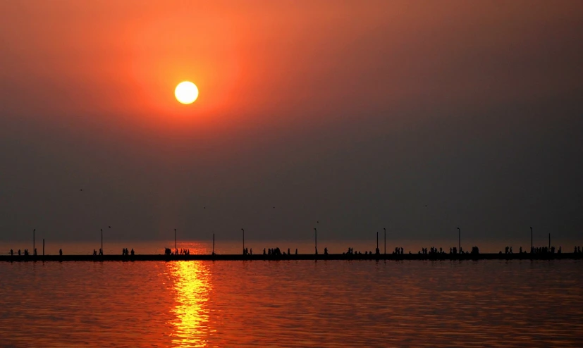 a sunset over the ocean with a sky background