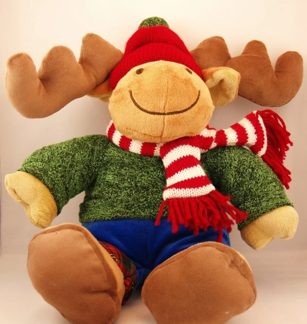 this moose is wearing a hat and scarf