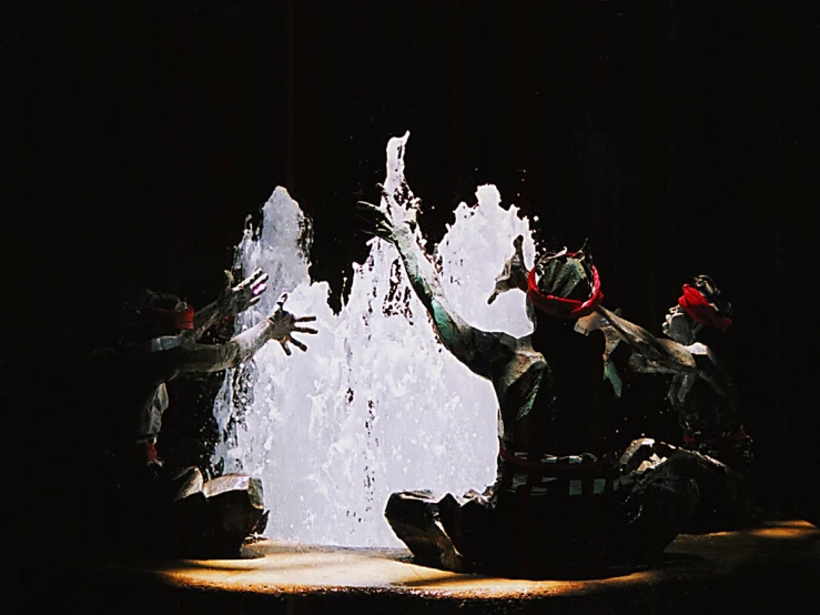 the three people have on their arms near a fountain