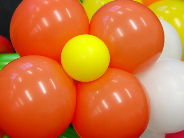 a group of balloons on the ground with helium around them