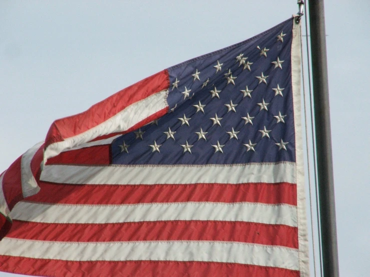 a flag flying on top of an american flag pole