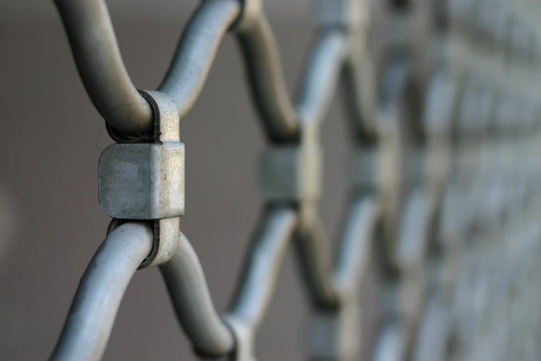 the side view of a fence with iron rods and lock