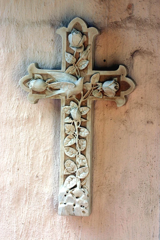 a cross with flower carvings on the outside