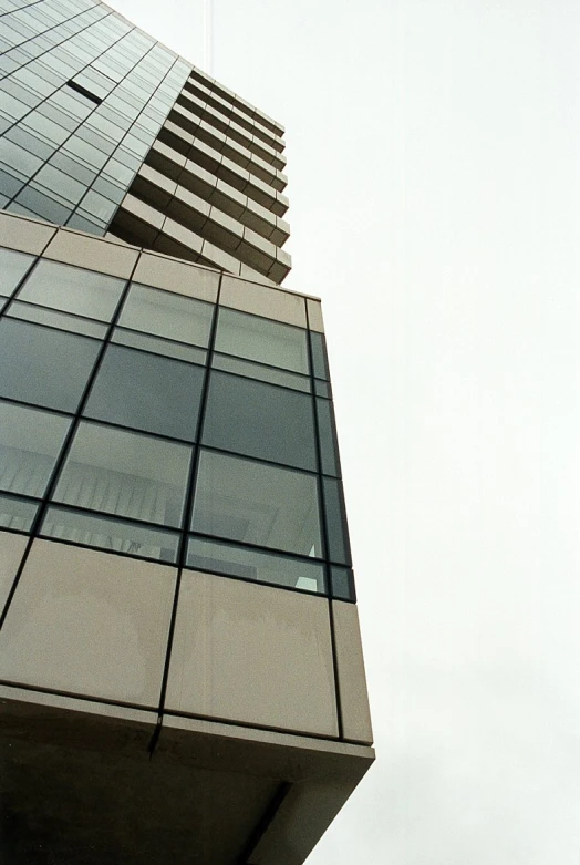 a large grey building that has a glass facade