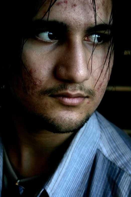 a young man with a beard and freckled make up on his face