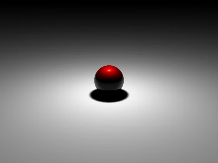 a red sphere sitting on top of a black table