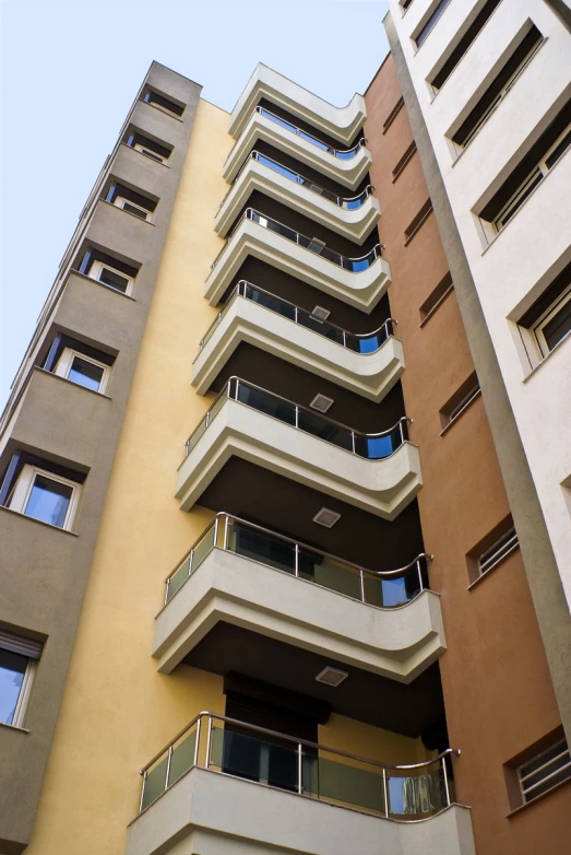 there are two multi colored buildings with balconies