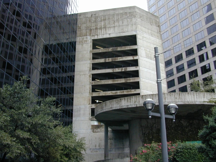 an old, concrete building sitting next to some high rise buildings