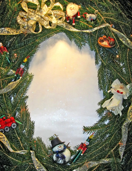 christmas wreath with various ornaments hanging in the center