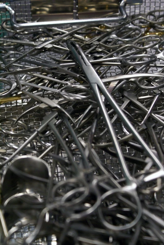 a pile of black and silver metal forks and scissors
