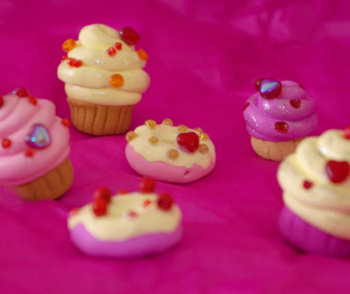 miniature cupcakes with pink frosting and red gummy stars